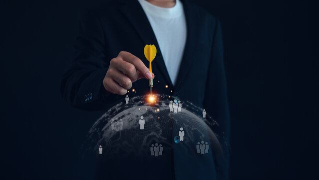 Business professional targeting global audience with dart on digital world network. Concept of customer targeting, market segmentation, audience analytics, lead generation and business growth.