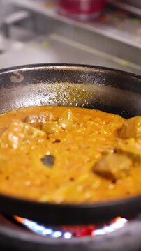 Chef Cooking Chicken Tikka Masala in Commercial Kitchen Frying Pan