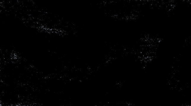 A dark and moody abstract texture featuring fine white speckled particles scattered across a deep black surface captured with high contrast for a gritty effect.