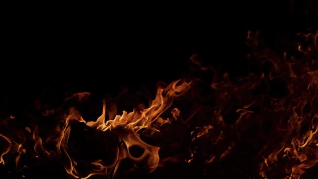 Fire blazing slow motion effect. Fire burning realistic flame shapes. Fire glowing deep contrast. Fire background for editing.