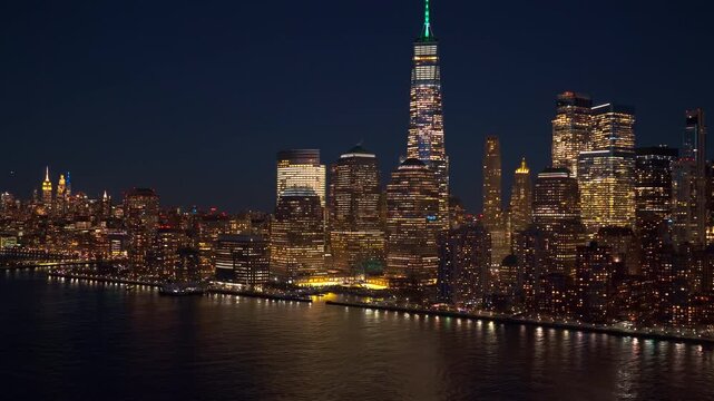 New York Manhattan cityscape over waterfront. New York skyline with blue tones. NYC panorama at night. New York Manhattan iconic landmark aerial view, NYC. New York City panorama at night.