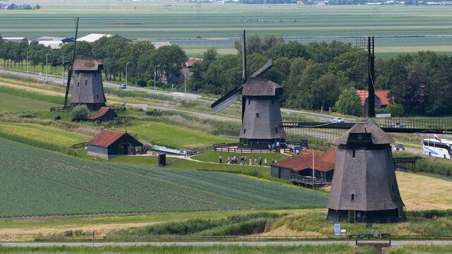 Aerial view of De Museummolen and surrounding historic windmills set in the lush green polder landscape of Schermerhorn, Noord-Holland, Netherlands.