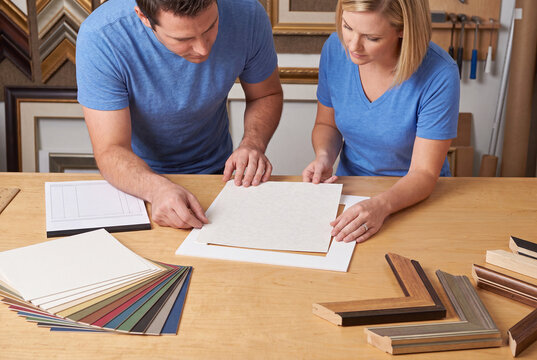 Professional Picture Framers Working in Workshop