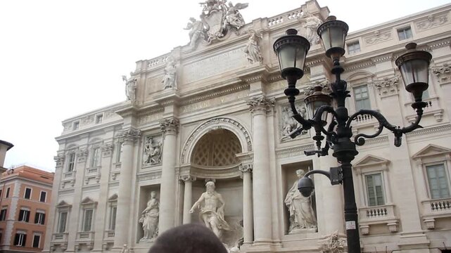 Vintage Street Lamp In Front Of Trevi Fountain On Cloudy Day  