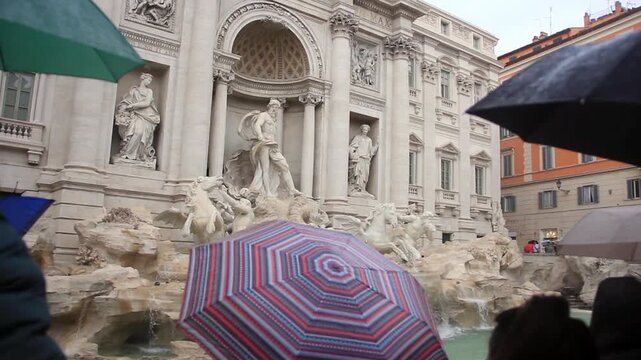 Tourists With Umbrellas At Trevi Fountain On A Rainy Day 