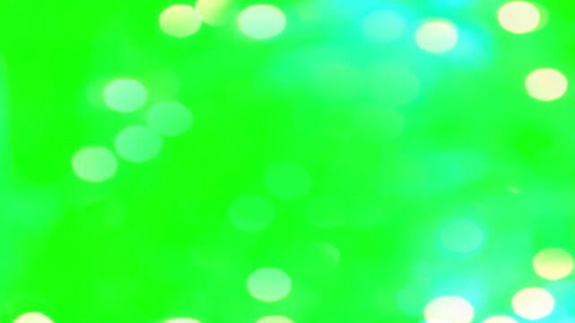 Soft blurry bokeh lights and abstract glowing particles on green screen background