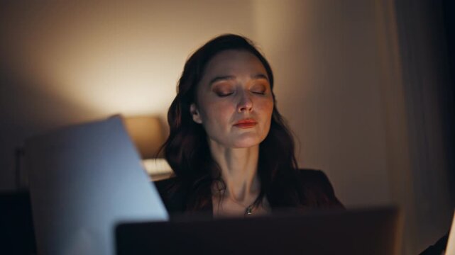 Night worker flipping papers comparing sitting office under lamp light closeup