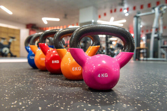 Close-up of 4kg kettlebells on floor. Kettlebells essential for strength training