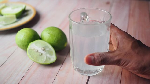 Making a drink with fresh limes and water at home