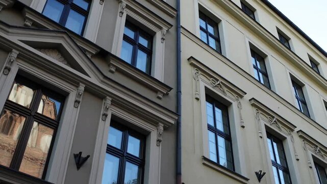 Building with many windows and a reflection of the sky.   Torun is city on Vistula River in north-central Poland and UNESCO World Heritage Site.