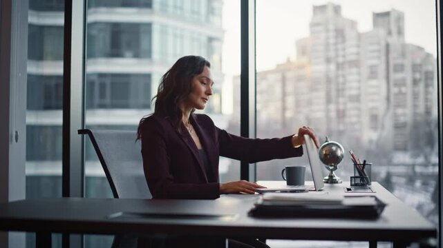 Girl freelancer opening laptop texting email at panoramic home office closeup