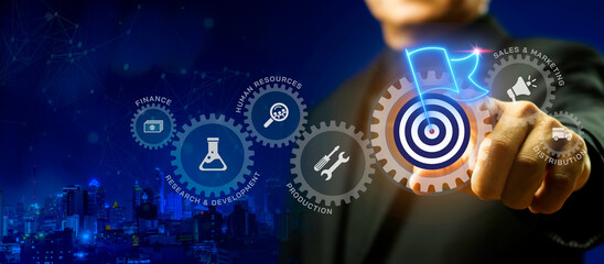 Fototapeta premium Businessman pointing at glowing gear with target flag icon. Milestone achievement, business objective and success concept.