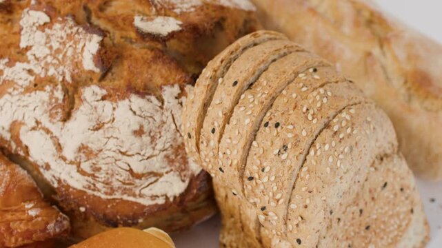 Assorted Fresh Bakery Breads and Pastries on White Background
