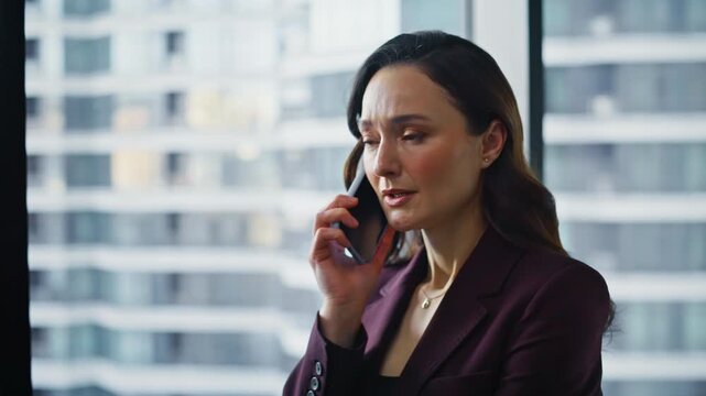 Wealthy business lady calling mobile phone standing office gesturing closeup