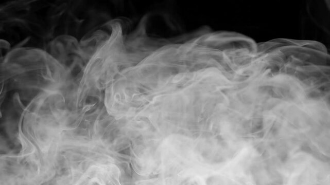 Whispering smoke swirls against a deep black background. Soft curves rise and fade in slow motion. This image captures motion, mystery, and tranquility. Use it for abstract, atmospheric