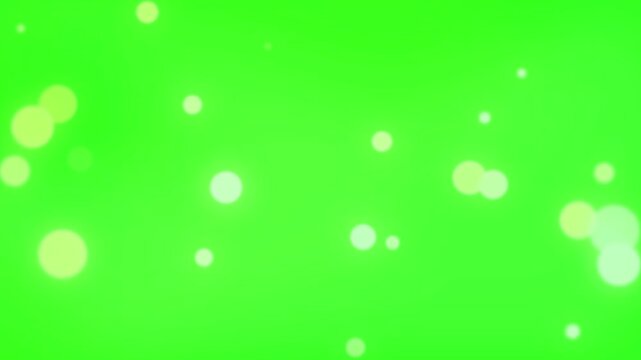 Abstract blurry particles and bokeh lights floating on green screen background
