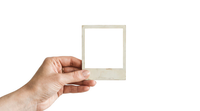 Hand holding an old vintage blank polaroid photo frame isolated on transparent background