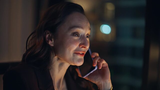 Calling woman manager working late talking positively at night office portrait