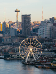 Fototapeta premium Seattle skyline with Space Needle and waterfront ferris wheel at sunset, urban cityscape, Washington USA. g.