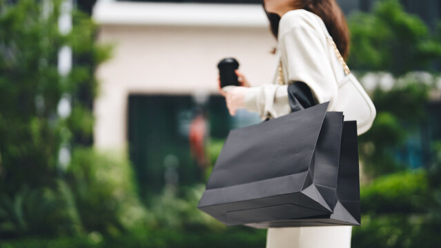 Single adult business asian woman holding coffee cup and shopping bag on black friday sale city people lifestyle