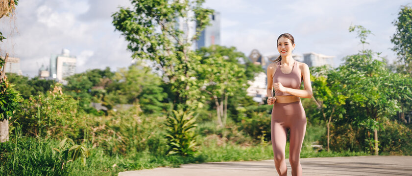 Beautiful asian exercise woman running at outdoors public park breathing fresh air wellness workout healthy lifestyle