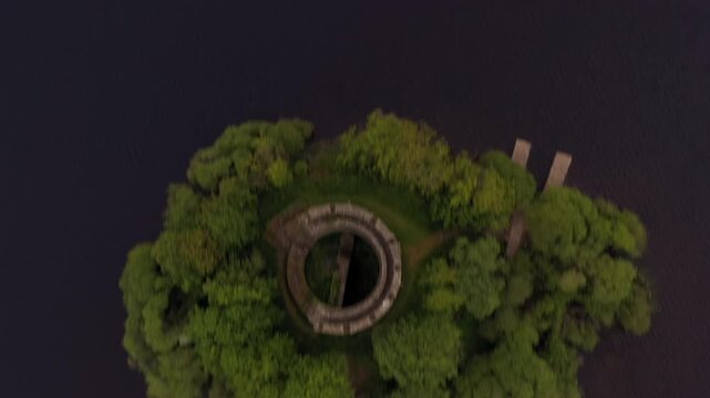 Aerial tilt down revealing Cloughoughter Castle on island, ending in top down bird's eye view, Lough Oughter County Cavan Ireland