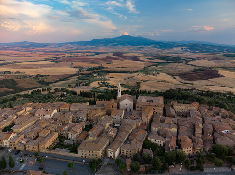 Aerial view of the historic town of Pienza with its terracotta rooftops, the Pienza Cathedral, and surrounding rolling hills of the Val d'Orcia landscape in Pienza, Tuscany, Italy.