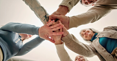 Obraz premium Hands, huddle and people in circle together for solidarity, teamwork or unity from below. Connection, palm and stack with family group in collaboration for celebration, motivation or support