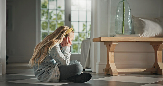 Thinking, sad and child in home on floor with loneliness, trauma or reflection for bad memory. Pensive, kid and girl with depression in apartment, mental health and deep thoughts with anxiety