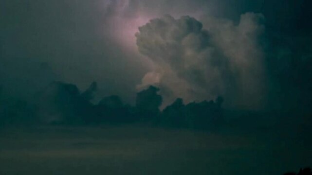 Night Thunderstorm with Lightning Flashing in Cumulonimbus Clouds. Monsoon Scenes Dark night of the flashing thunderstorm sky.