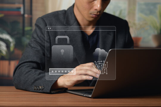 Young Man Using Laptop for Cybersecurity and Data Protection at Desk