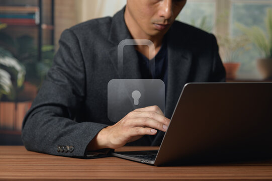 Businessman Using Laptop and Digital Security Concept at Desk