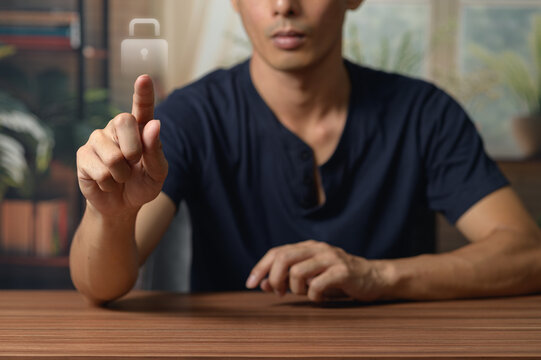 Modern young man in casual shirt using touchscreen device in indoor setting