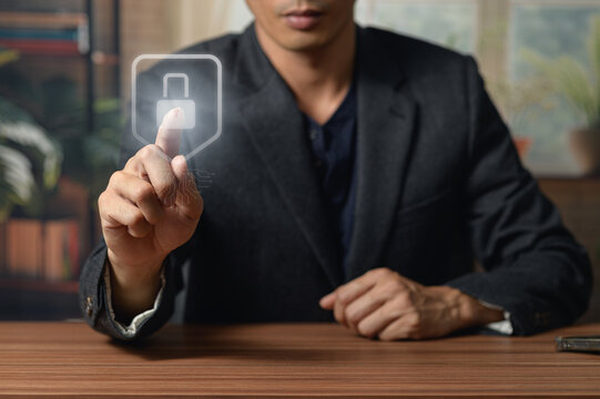 Businessman Using Touchscreen Interface with Lock Icon in Modern Office Setting