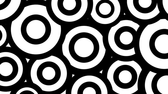 A dense seamless black and white pattern of large overlapping concentric rings creating bold graphic wallpaper art
