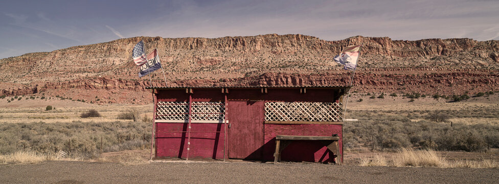 Stratified sandstone escarpment wall above an arid desert plain