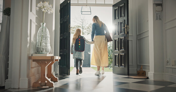 Mom, leaving and girl in home with backpack, support and back to school for education. Woman, walking or front door with daughter for commute, morning routine and bonding together for learning