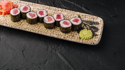 Tuna maki sushi rolls on plate with wasabi and ginger © AntAlexStudio