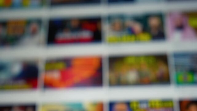 Blurred wall of colorful screen thumbnails in a grid, abstract media background with soft focus and bright colors