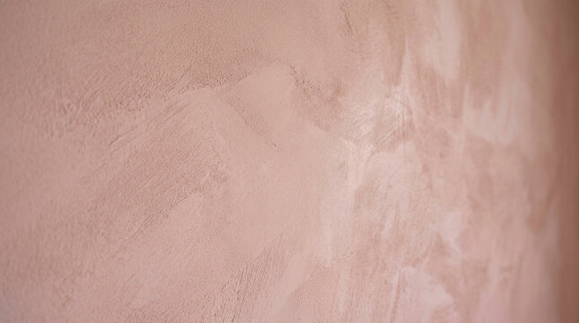 Polished pink plaster wall texture, decorative venetian stucco finish, soft rose cement surface for interior design and architectural backgrounds