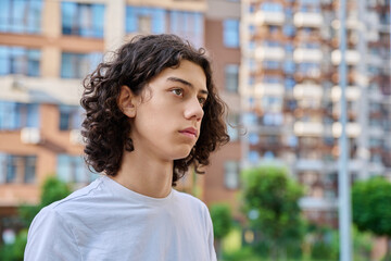 Profile portrait of curly teen boy outdoors © Valerii Honcharuk