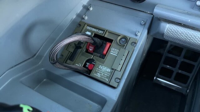 ERJ Cockpit Oxygen Mask Stowage Box With Its Red Emergency Toggle. - high angle shot