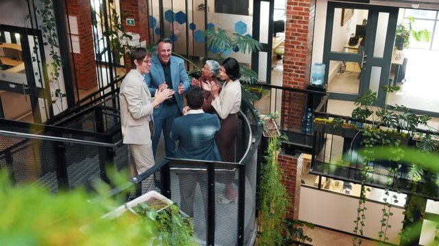 Team, stairs and business people with hand stack, applause and contract success at creative agency. Green office, above and workers with solidarity, achievement or celebrate at interior design firm