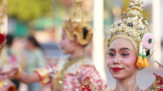 Traditional Thai Dancer in Ornate Gold Chada Headdress at Outdoor Festival