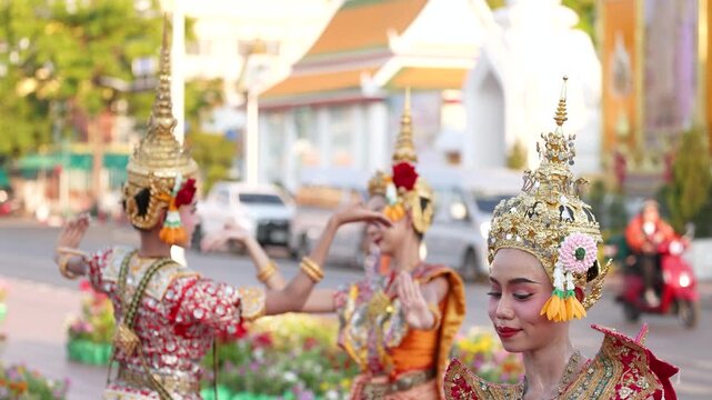 Traditional Thai Dancers Performing in Ornate Gold Costumes Outdoors