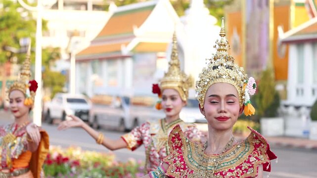 Traditional Thai Dancers Performing in Ornate Costumes Near Temple