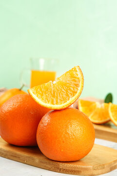 Fresh Orange Slices and Juice on Wooden Board