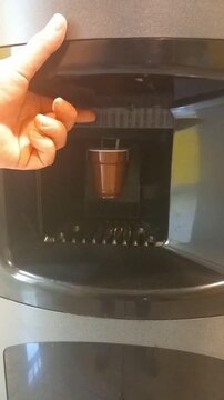 Coffee Dispensing into Plastic Cup from Vending Machine Close Up