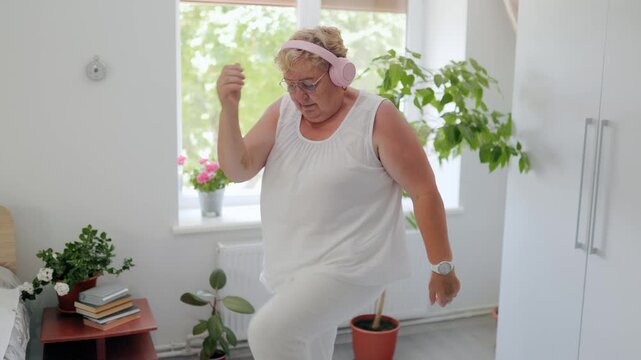 Active mature lady marching in place during home cardio exercise fitness at home