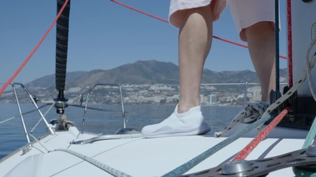 Young man preparing sailboat for journey